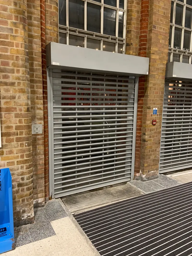 brick arches with old grilles across the openings.