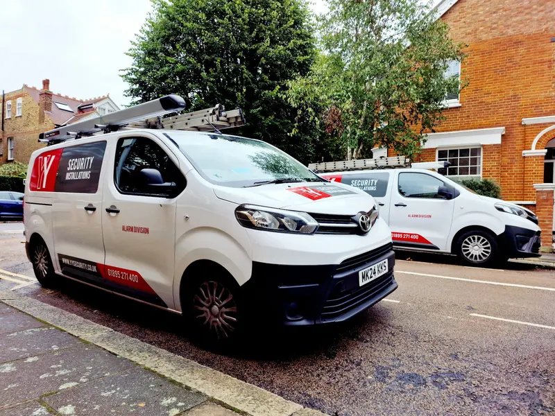 Two YY Security vans with the red YY mark parked on a London street